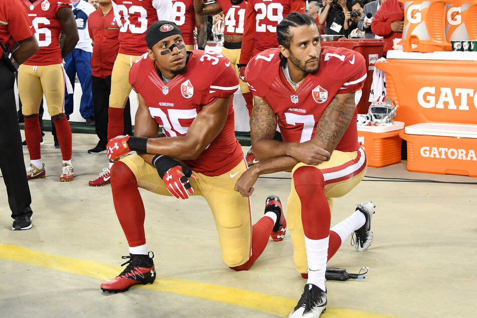 In 2016, Colin Kaepernick (r.) faced significant backlash for kneeling during the national anthem. He has not played in the NFL since.