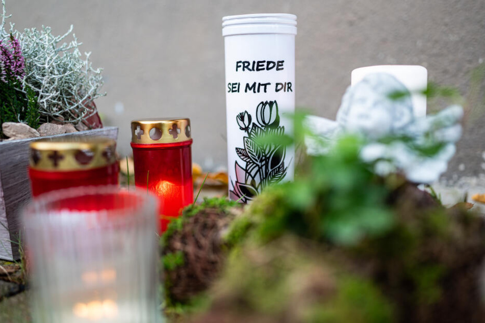 Vor dem Haus, wo der Dreijährige getötet wurde, legten Menschen Blumen und Kerzen hin.