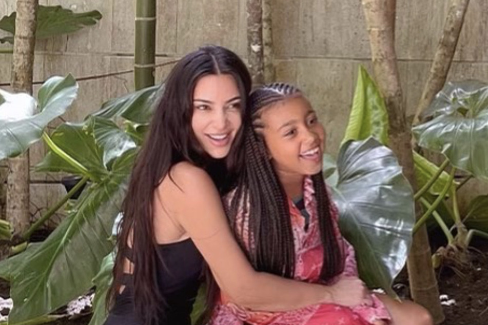 Kim Kardashian is all smiles as she poses with her daughter, North West.