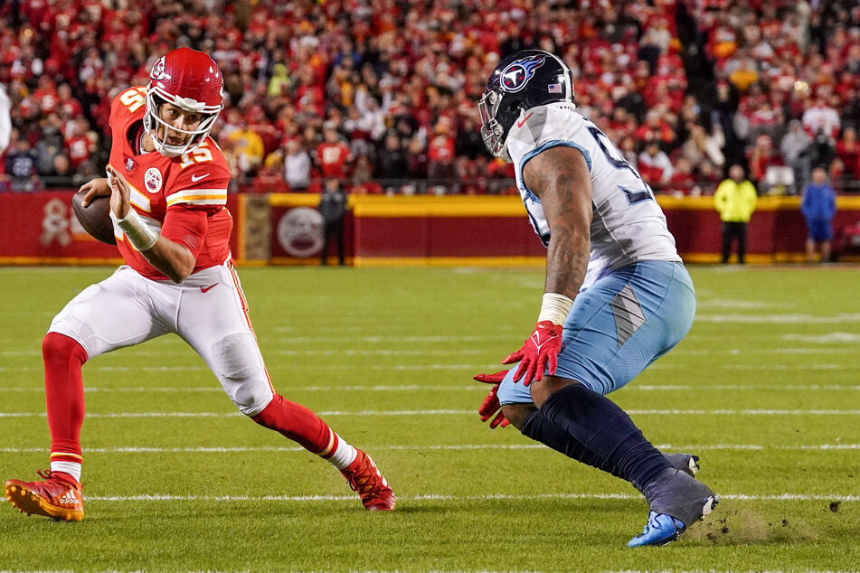 Mahomes runs the ball against Tennessee Titans defensive end Denico Autry during the second half of the game.
