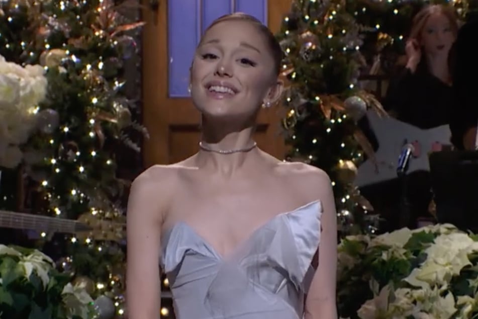 Ariana Grande joked about gift shopping for strangers to the tune of Mariah Carey's All I Want For Christmas during her SNL opening monologue.