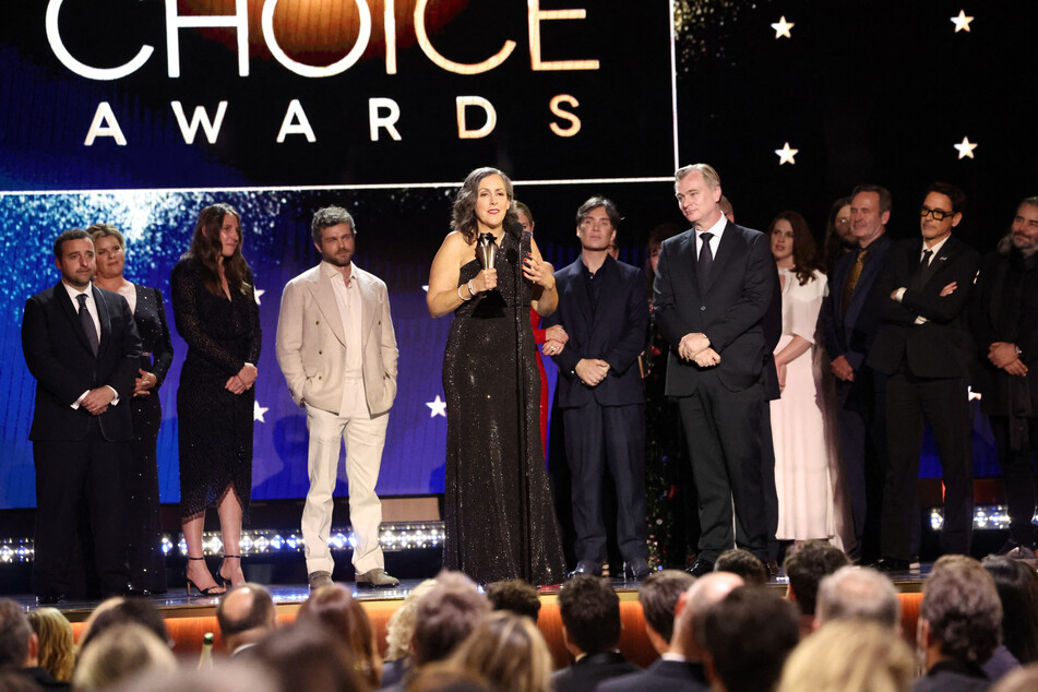 Emma Thomas and Christopher Nolan with other cast and crew members receive the Critics Choice Award for Best Picture for Oppenheimer during the 29th Annual Critics Choice Awards in Santa Monica, California.