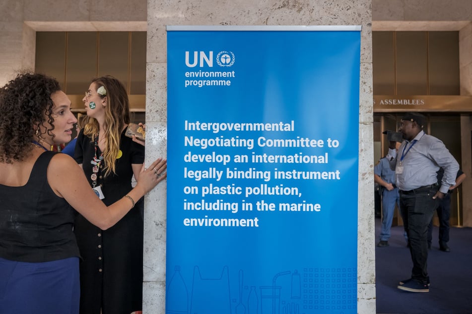 Activits stands next to the assembly hall on the final day of negotiations of a landmark global treaty on plastic pollution, at the United Nations Offices in Geneva on August 14, 2025.