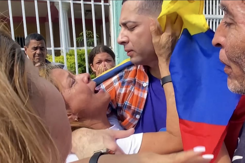Maikel Olivera embraces his mother Olivia Rojas as he reunites with his family in Barquisimeto, Lara State, Venezuela, on July 22, 2025.