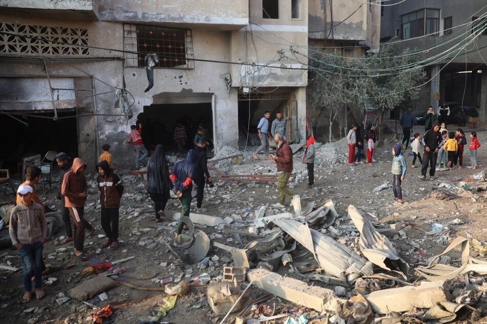 Palestinians check the damage in an area targeted by an Israeli airstrike early on December 12, 2024, near the Nuseirat refugee in the central Gaza Strip.