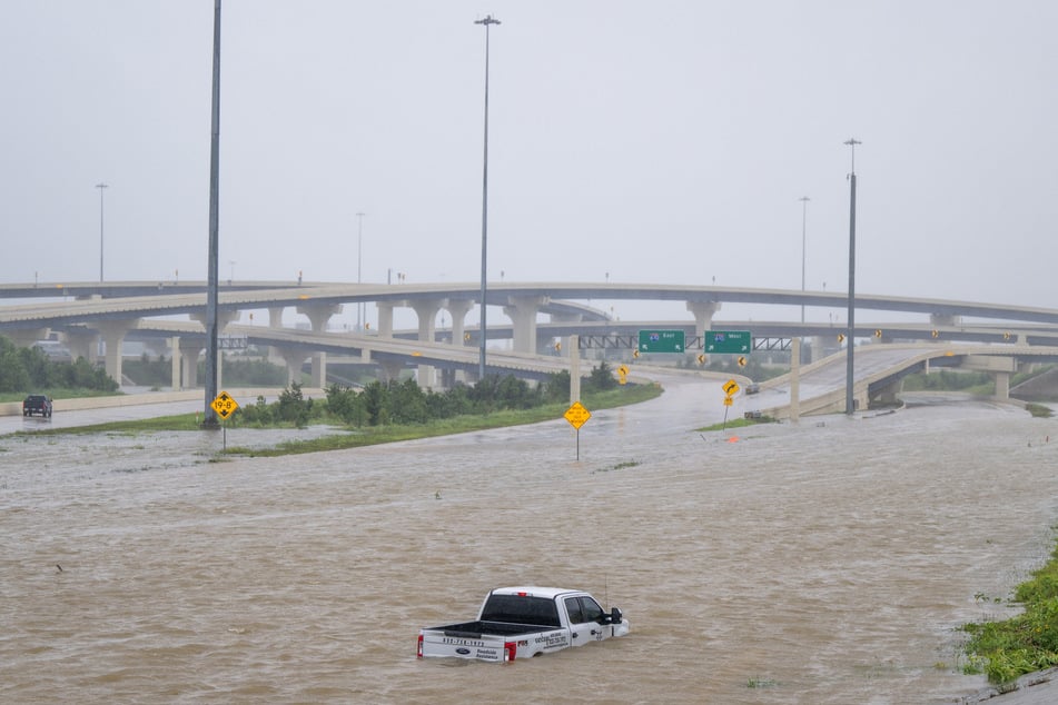 A vehicle is left abandoned in floodwater on a highway after Hurricane Beryl swept through the area on July 08, 2024 in Houston, Texas.