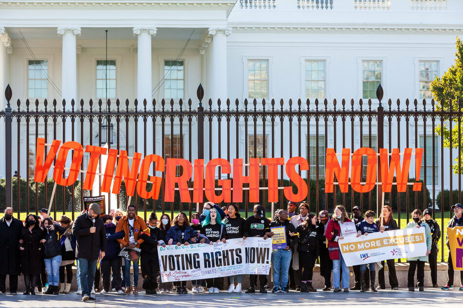 Voting rights activists rally in front of the White House to demand ballot access protections.