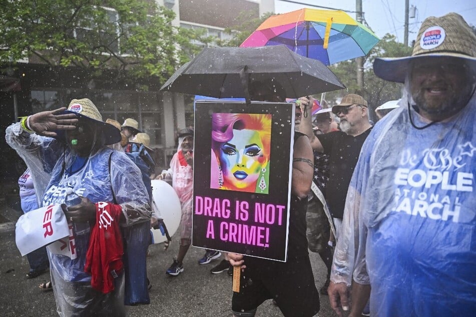 A demonstrator carries a sign reading "Drag Is Not a Crime" during a march in Fort Lauderdale, Florida.