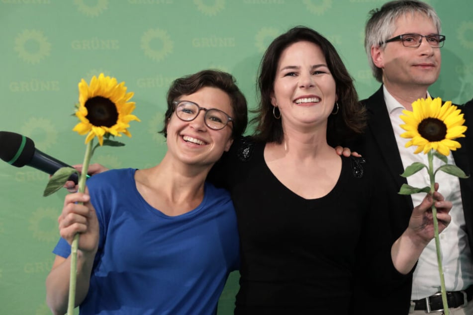 Hannah Neumann (l.), Annalena Baerbock (m.) und Sven Giegold (r.) lächeln nach der Bekanngabe der ersten Prognose für die Europawahl.
