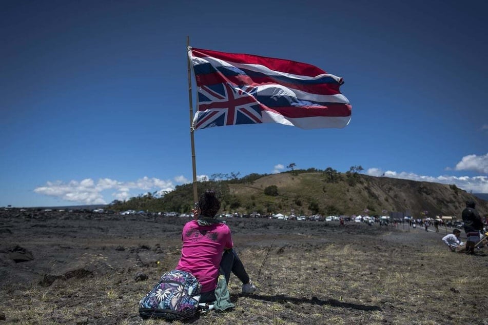 Demonstrators gather by the Mauna Kea Access Road to protest the construction of a massive telescope on land Hawaiian nationals consider sacred.