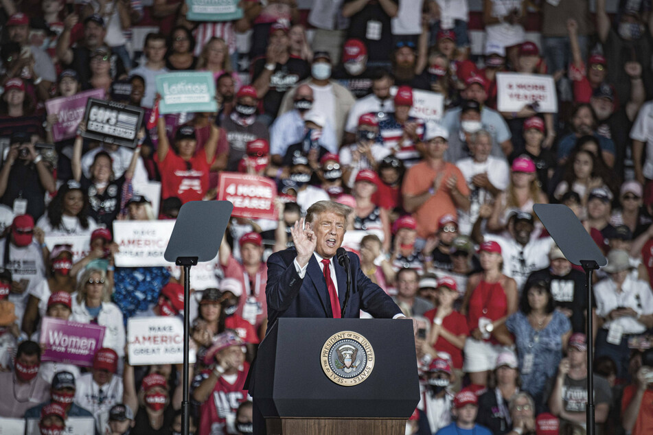 President Donald Trump delivering a speech in front of supporters at the Orlando Sanford International Airport.