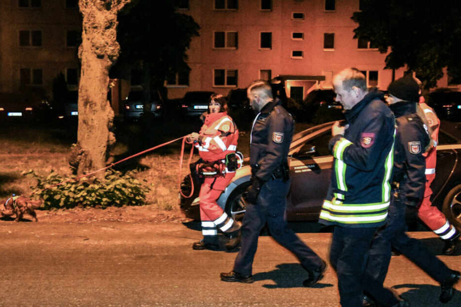 Polizisten und ein Feuerwehrmann bei der Suche nach dem vermissten sechsjährigen Mädchen. (Archivbild)