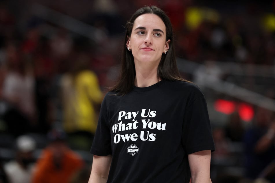 Caitlin Clark of the Indiana Fever wears a shirt saying "Pay Us What You Owe Us" prior to the 2025 AT&amp;T WNBA All-Star Game at Gainbridge Fieldhouse on July 19, 2025.