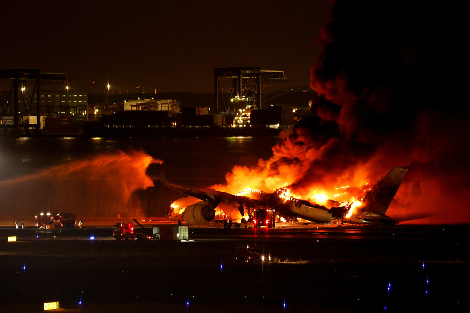 A Japan Airlines plane caught fire on the runway of Haneda Airport in Tokyo after reportedly crashing into another aircraft.