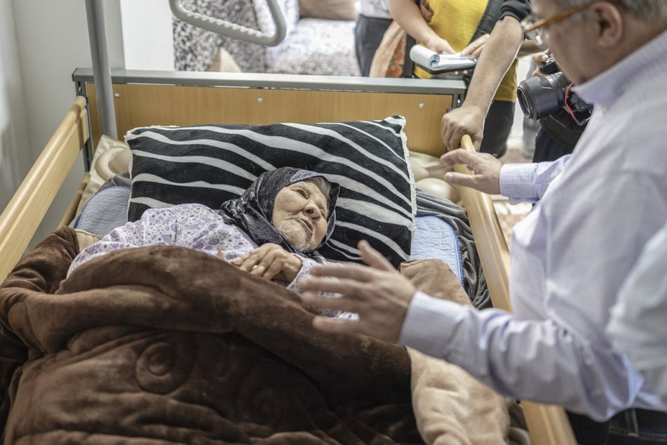 Arab-Israeli member of the Israeli parliament Ahmed Tibi meets elderly Palestinian resident Yusra Qwaider in the neighborhood of Silwan during a tour by diplomats and media members in Israeli-annexed east Jerusalem on April 23, 2026.