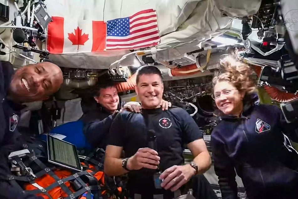 This screengrab taken from a NASA livestream shows Artemis II mission astronauts (L-R) NASA's pilot Victor Glover, NASA's commander Reid Wiseman, Canadian Space Agency's mission specialist Jeremy Hansen and NASA's mission specialist Christina Koch as they attend a "VIP call" with Canadian children from inside the Orion spacecraft while on their way to the Moon on Saturday.