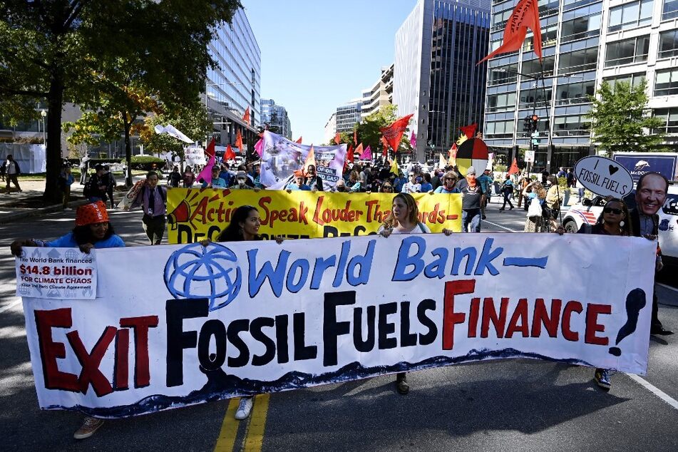 Climate activists protest outside the World Bank headquarters against fossil fuel projects in Washington DC on October 14, 2022.
