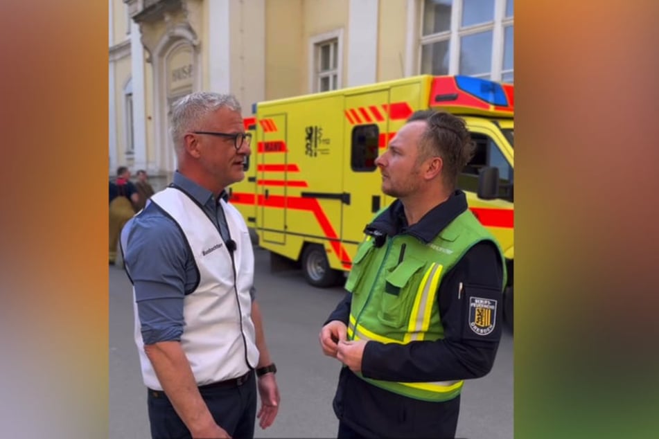 Doktor Andreas Noack (l.) teilt Feuerwehr-Sprecher Michael Klahre (r.) mit, wie die Evakuierung des Städtischen Klinikums verläuft.