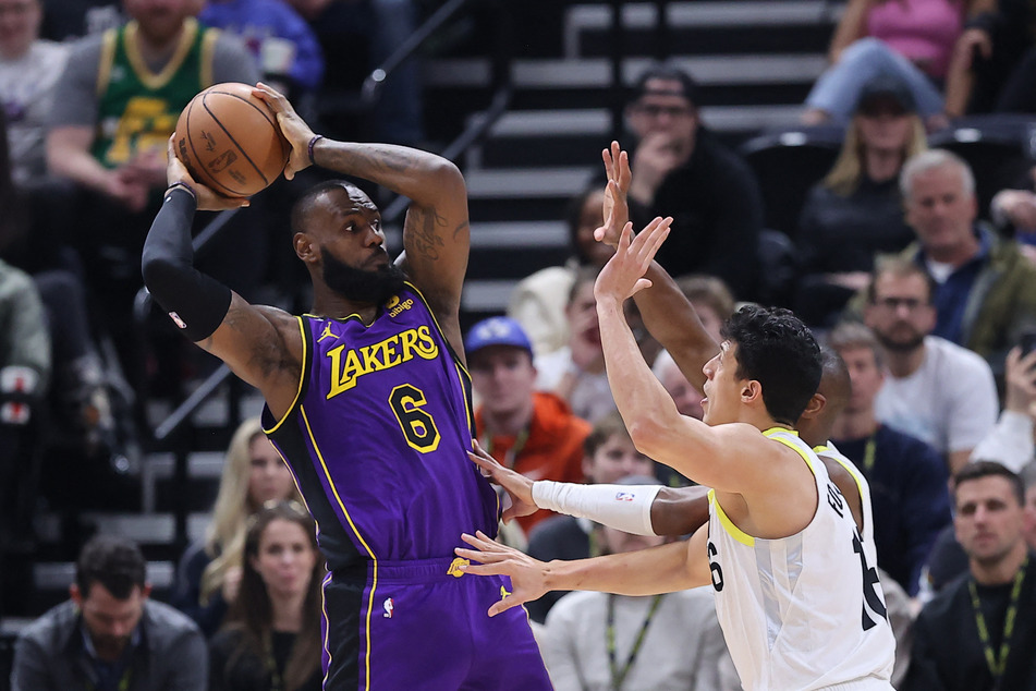 Los Angeles Lakers forward LeBron James passes the ball over Utah Jazz forward Simone Fontecchio in the third quarter at Vivint Arena.
