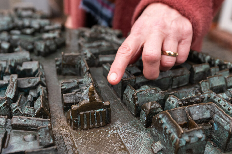 Heike Düselder, Museumsdirektorin, zeigt auf einem Modell auf das Rathaus der Stadt Lüneburg.