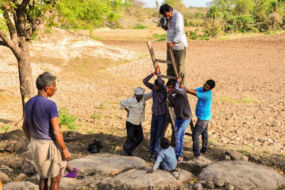 Dorfbewohner helfen einem Paläontologen beim Fotografieren eines Nests mit versteinerten Dinosauriereiern. Mehr als 250 solcher Eier wurden in den vergangenen Jahren im Bezirk Dhar von Madhya Pradesh gefunden.