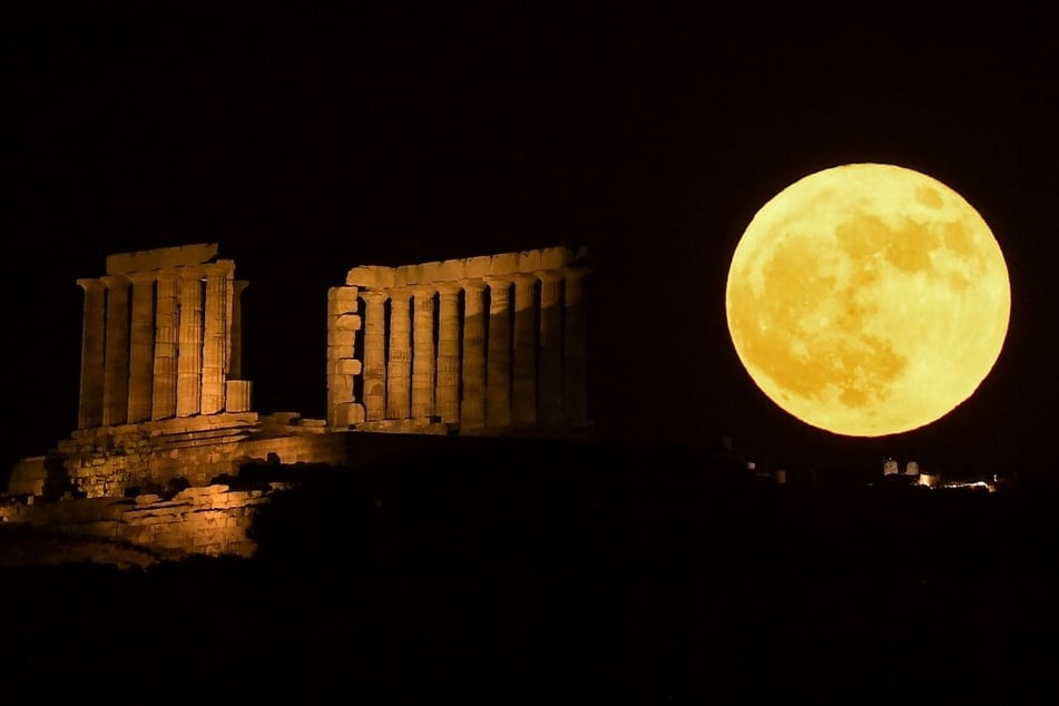 This is the strawberry moon behind the Temple of Poseidon at Cape Sounion, south of Athens, on Tuesday night.