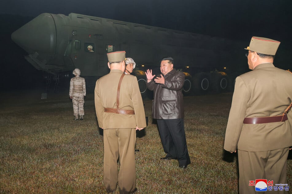 This picture taken on October 31, 2024 and released by North Korea's official Korean Central News Agency (KCNA) via KNS on November 1, 2024 shows North Korean leader Kim Jong Un (center r.) before the test-fire of the new Hwasong-19 intercontinental ballistic missile (ICBM) at an undisclosed location in North Korea.