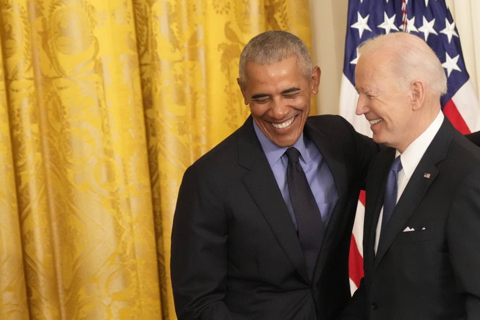 Obama, back at White House with Biden, celebrates his health care law