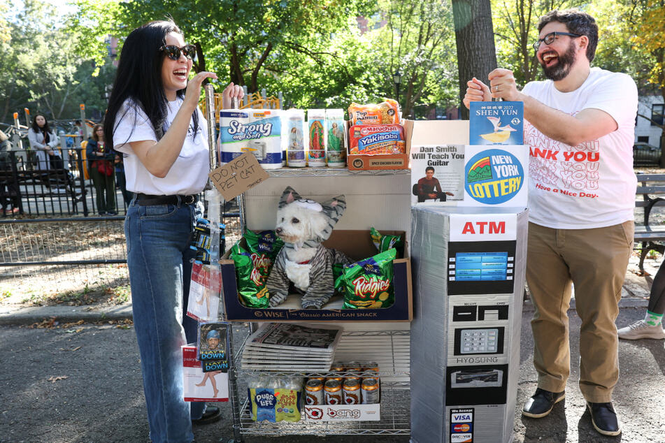 A Bichon dressed as a bodega cat, named Mimi, won a Judges Pick honor in a group costume with owners Kat Liu and Kevin Condardo.