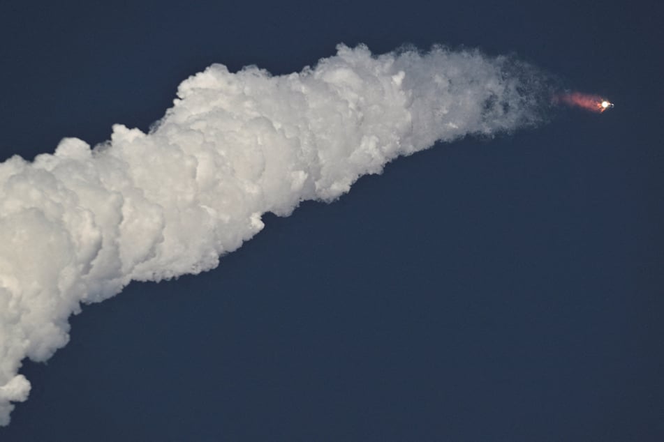 A SpaceX Super Heavy booster carrying the Starship spacecraft roars into the skies on August 26, 2025.