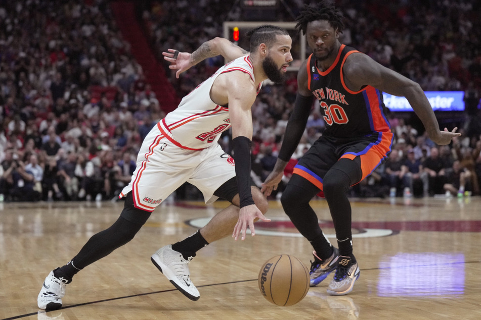 Miami Heat forward Caleb Martin (l.) faces off against New York Knicks forward Julius Randle (30) during their NBA game in Miami.