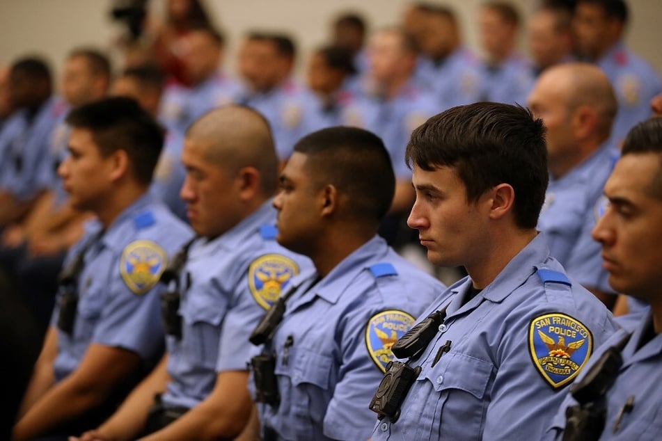 San Francisco police recruits look on during a news conference at the San Francisco Police Academy.
