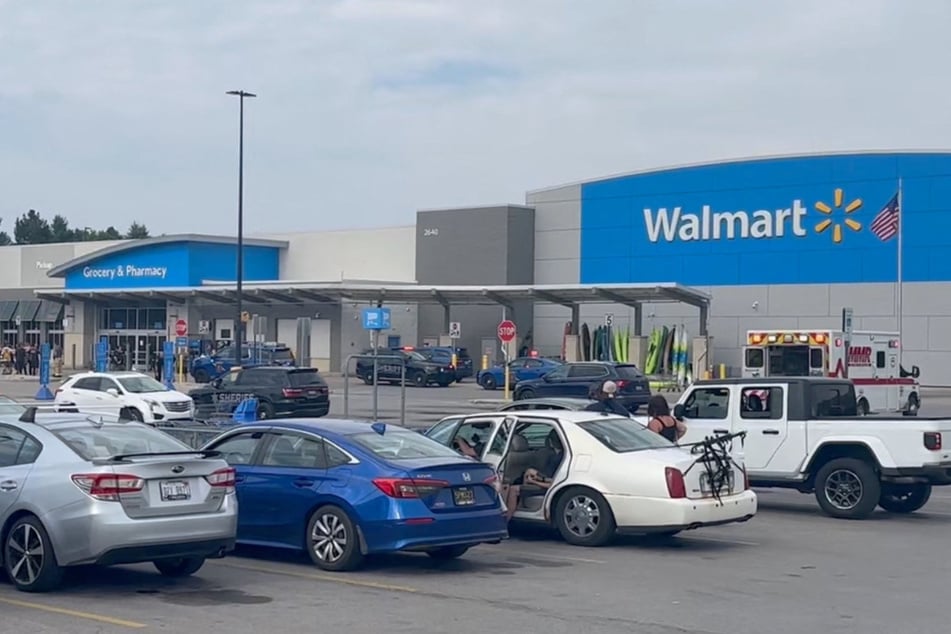 Emergency personnel stand outside a Walmart store in Traverse City, Michigan, after a stabbing incident on July 26, 2025.