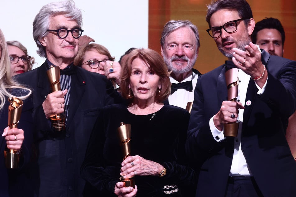 Filmemacher Wim Wenders (80, l.) erhielt den Ehrenpreis für sein Lebenswerk. Senta Berger (85, m.), hier mit Regisseur Simon Verhoeven (53, r.), wurde erstmals für eine "Lola" nominiert und gewann direkt als beste Hauptdarstellerin für ihre Rolle in "Ach, diese Lücke, diese entsetzliche Lücke".