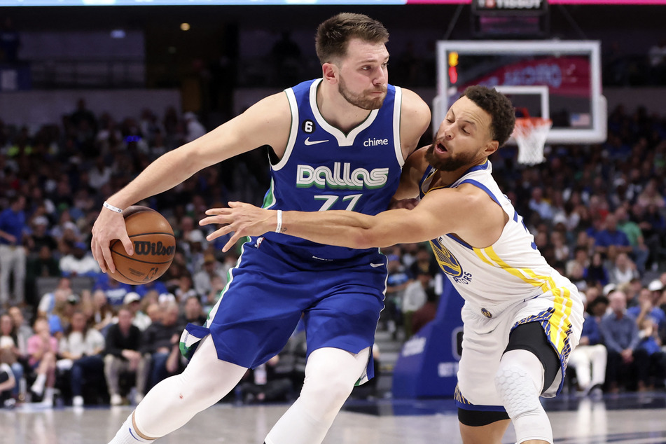 Dallas Mavericks guard Luka Doncic controls the ball as Golden State Warriors guard Stephen Curry during the second half at American Airlines Center.