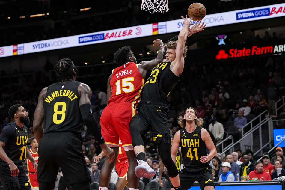Atlanta Hawks center Clint Capela and Utah Jazz forward Lauri Markkanen fight for a rebound during the first half at State Farm Arena.