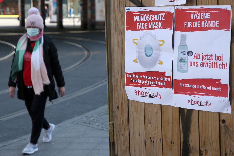 Werbeplakate für Mundschutz und Desinfektionsmittel zur Vorbeugung gegen Coronavirus-Infektionen hängen am Alexanderplatz.