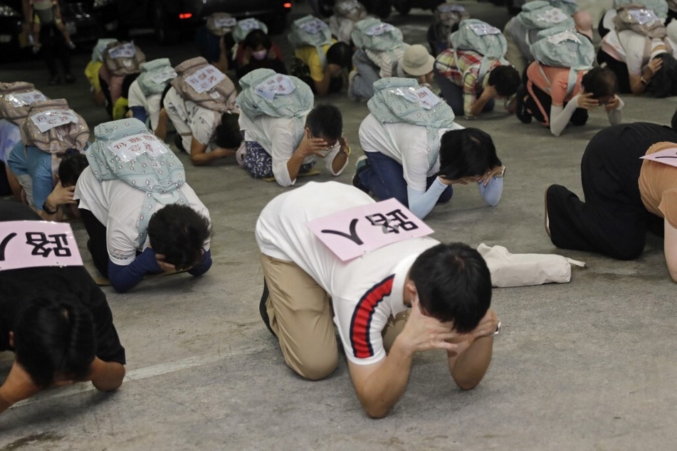 Local residents take shelter during the Wanan Air Raid Drill, a civilian air-raid held on the day of the annual Han Kuang military exercise, in Taipei, Taiwan.