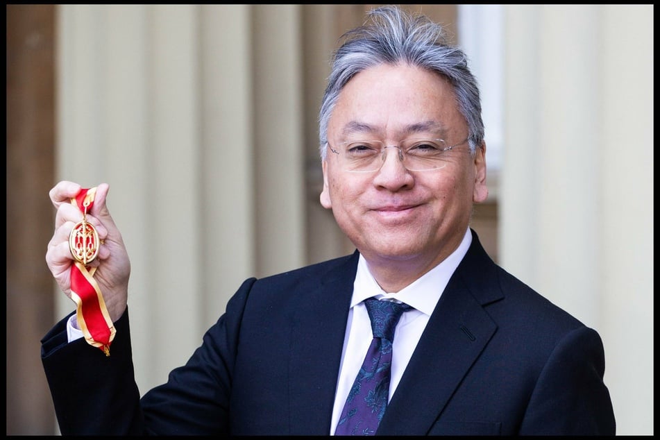 Sir Kazuo Ishiguro poses with his medal after being knighted in 2019 at Buckingham Palace.