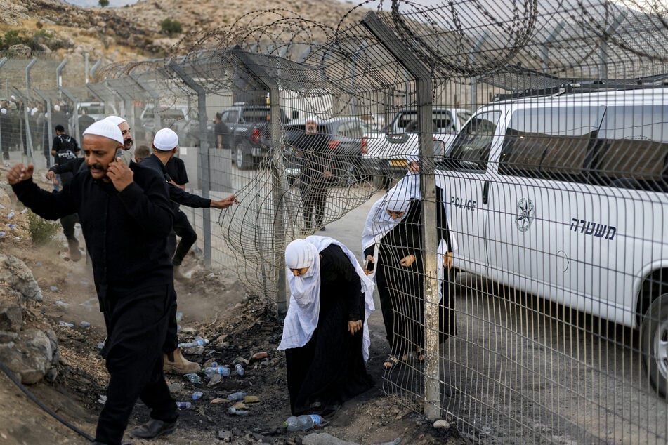 Members of the Druze community passing through a hole in the barbed-wire border fence in the Israeli-annexed Golan Heights near Majdal Shams on Wednesday.