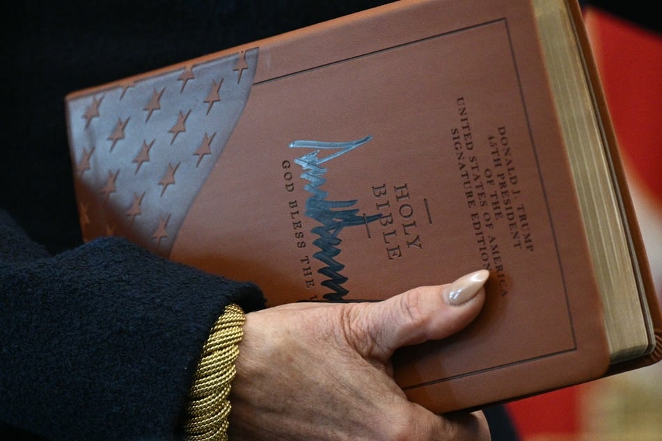 Attorney for the District of Columbia Jeanine Pirro holds the Holy Bible signed by President Donald Trump during a White House event on November 10, 2025.