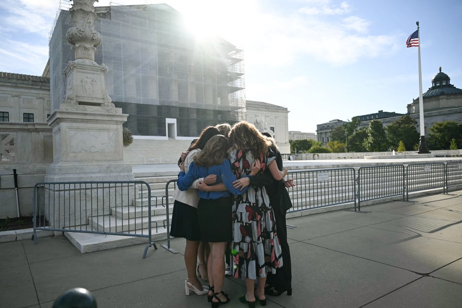 Members of the group "Concerned Women for America" pray outside the US Supreme Court as the Court hears oral arguments in Chiles v. Salazar, a landmark case on "conversion therapy," on Tuesday, in Washington, DC.