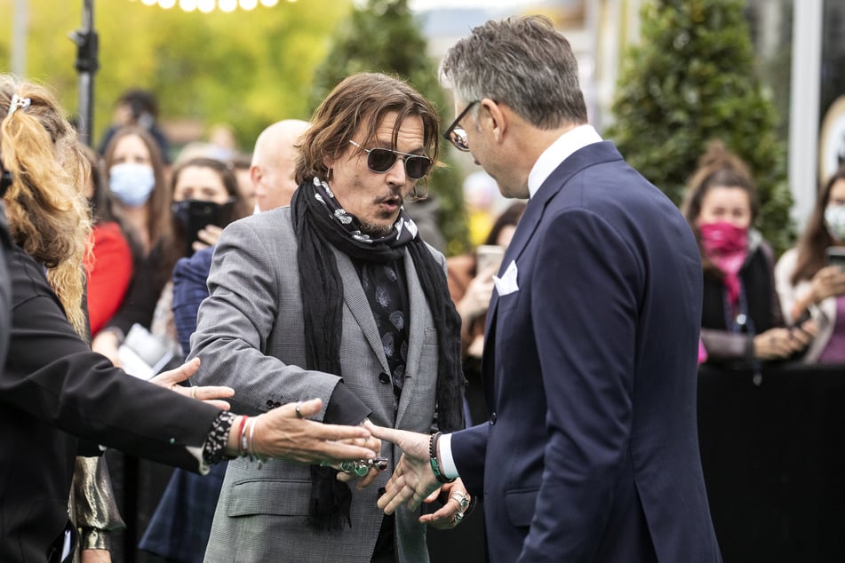 Johnny Depp and Christian Jungen (r.), artistic director of the Zurich Film Festival, greet each other during the 16th Zurich Film Festival.
