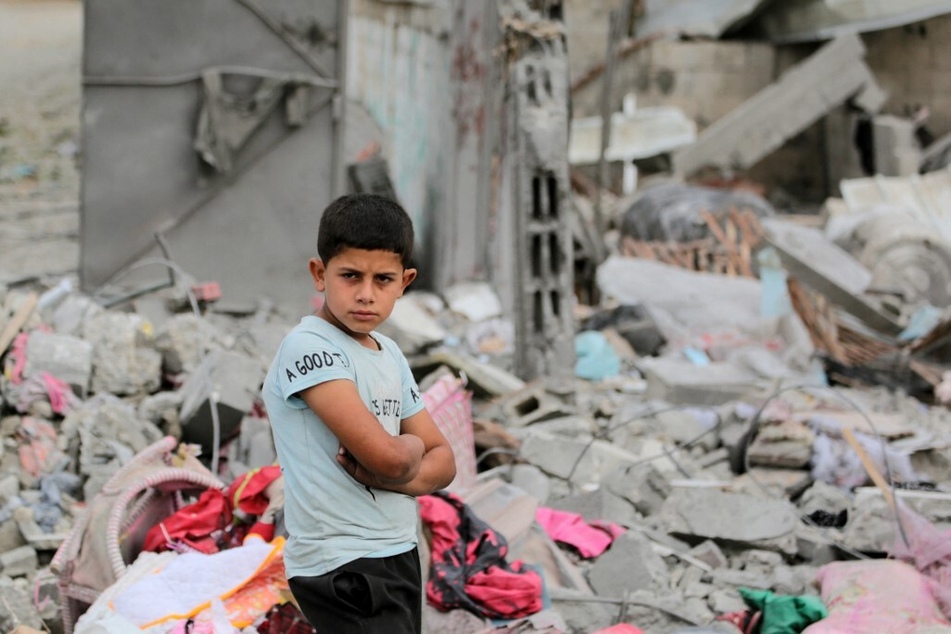 A Palestinian boy stands amid the rubble of a residential building destroyed by an Israeli strike in Al-Zawayda in the central Gaza Strip on May 11, 2024.