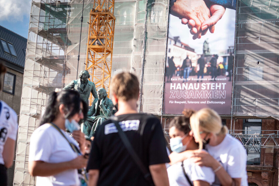 Ein neues Banner mit der Aufschrift "Kein Platz für Rassismus und Gewalt - Hanau steht zusammen für Respekt, Toleranz und Zivilcourage" hängt an der Fassade des Rathauses vor dem Gebrüder-Grimm-Denkmal.