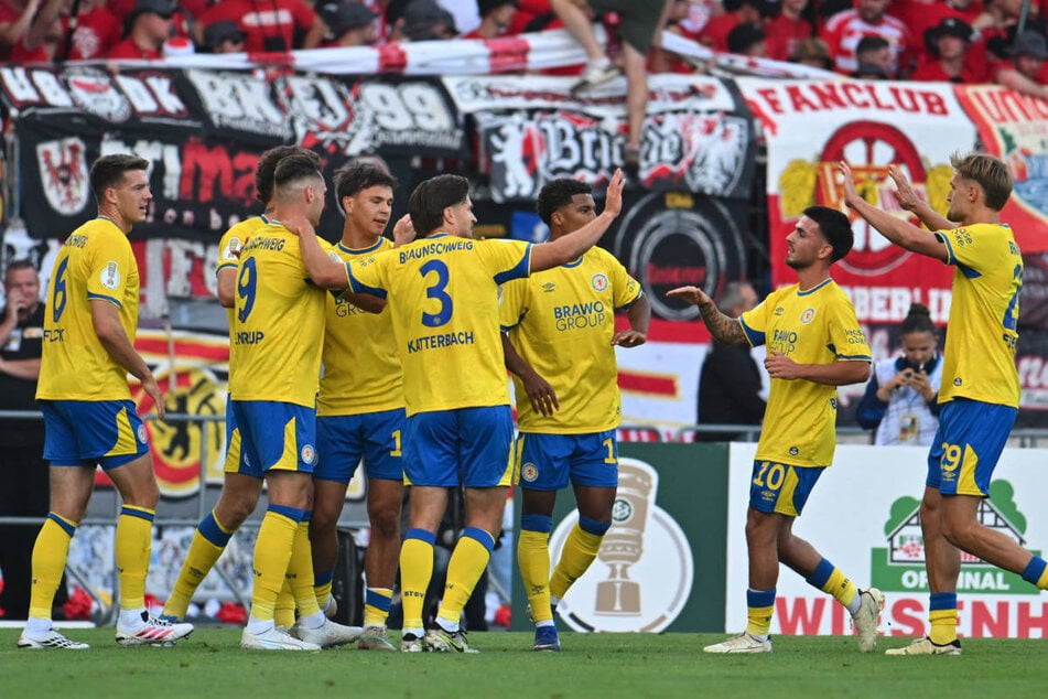Eintracht Braunschweig feiert den Führungstreffer von Max Marie (3.v.l.) vor dem Union-Block.