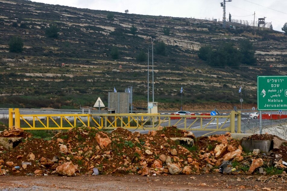 A metal barrier as well as a pile of rocks and earth placed by Israeli troops block the northern entrance to Ramallah, on a road linking the occupied West Bank city to Nablus and other areas.
