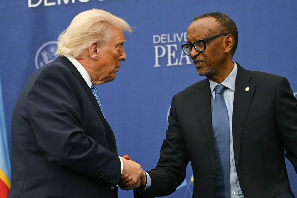 US President Donald Trump (l.) shakes hands with President of Rwanda Paul Kagame during the signing ceremony of a peace deal between Rwanda and the Democratic Republic of the Congo in Washington DC on December 4, 2025.