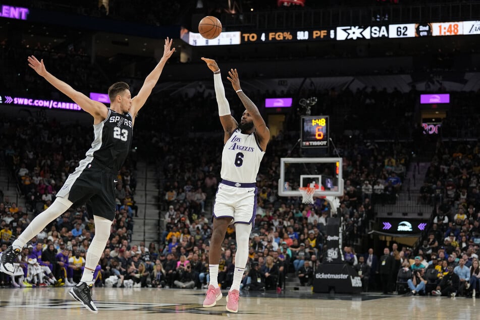 Los Angeles Lakers forward LeBron James shoots over San Antonio Spurs forward Zach Collins in the first half at the AT&T Center.