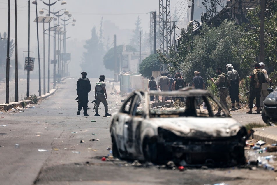 Bedouin and tribal gunmen keep a position during clashes with Druze fighters in Syria's southern city of Sweida, despite an announcement by the Syrian interim president of an "immediate ceasefire" on Saturday.